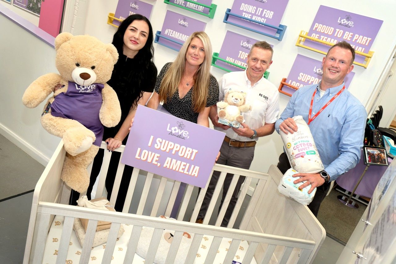 Members from Karbon Homes and RE:GEN and Love, Amelia charity stand around a cot to promote a new safe sleep programme to help families and children in the North East