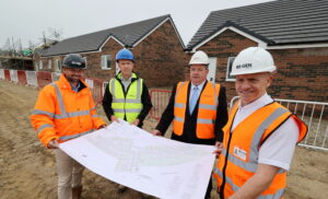 Team picture of four people from REGEN, Bernicia and Sunderland city council on a new build site in Sunderland